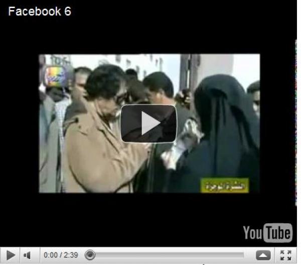 القذافي يكشف نقاب امرأة 