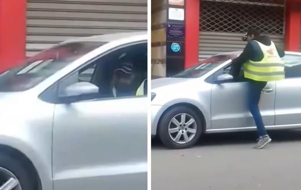 حارس سيارات يتسلل إلى سيارة عبر النافذة و يفتش أغراضها