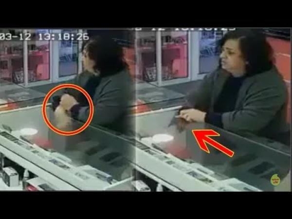 امرأة تسرق بورطابل من احد محلات بيع الهواتف