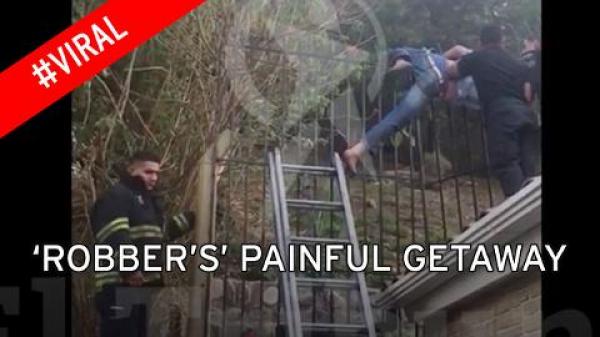 بالفيديو: لص يوقظ أصحاب منزل بعد أن علق بالسور